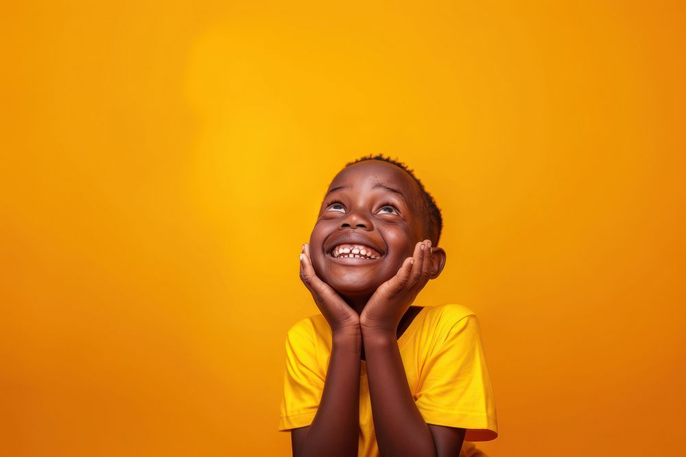 African kid hands cupping face happy surprised laughing.
