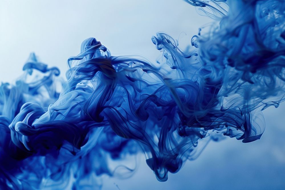 Blue ink wave flowing underwater blue smoke backgrounds.