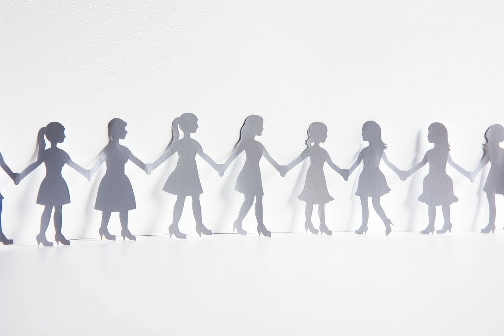 Paper cutouts of people holding hands silhouette human kid.