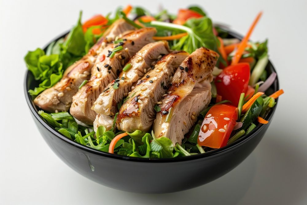 Chicken with vegetables in black bowl lunch food meal.