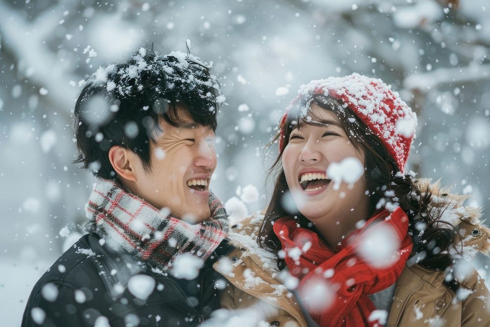 Happy korean couple snow medication outdoors.