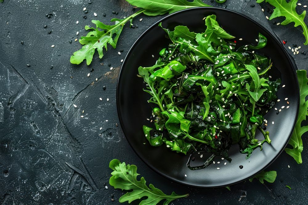 Seaweed Salad in black plate vegetable arugula produce.