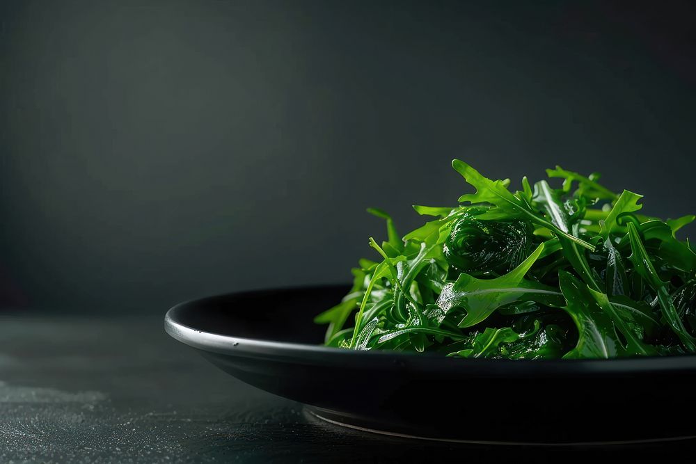 Seaweed Salad in black plate vegetable produce arugula.
