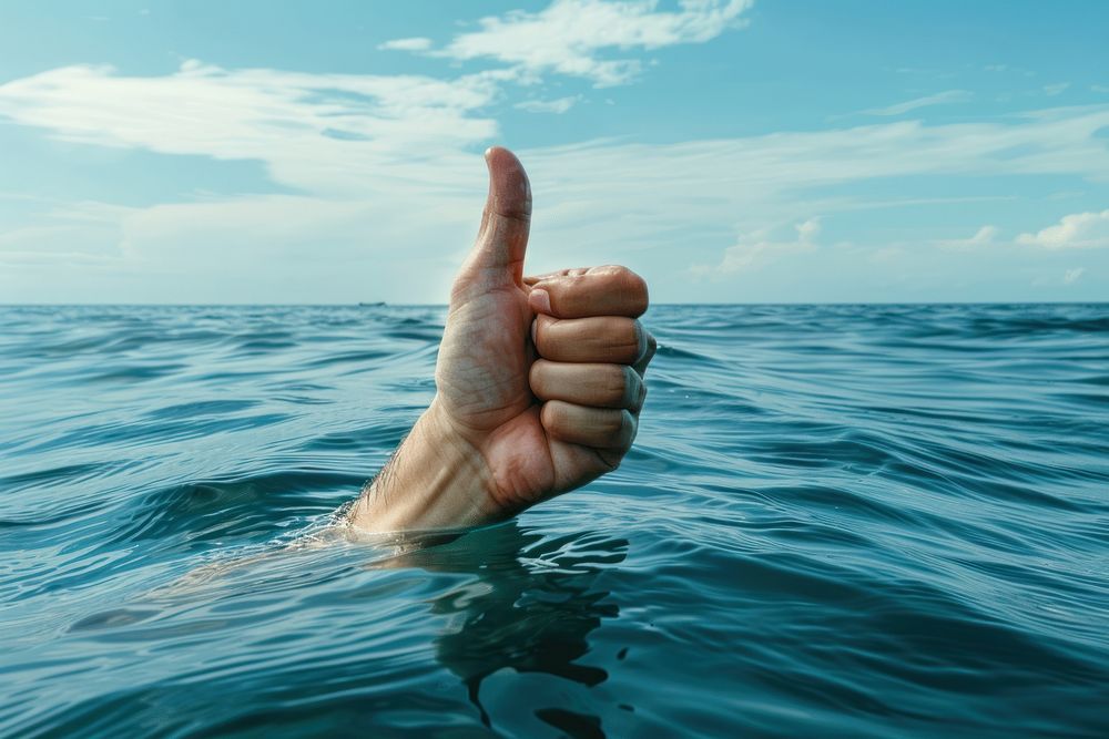 Sinking hand gesturing thumbs-up in sea finger person human.