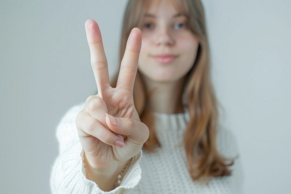Person making a peace sign finger female human.