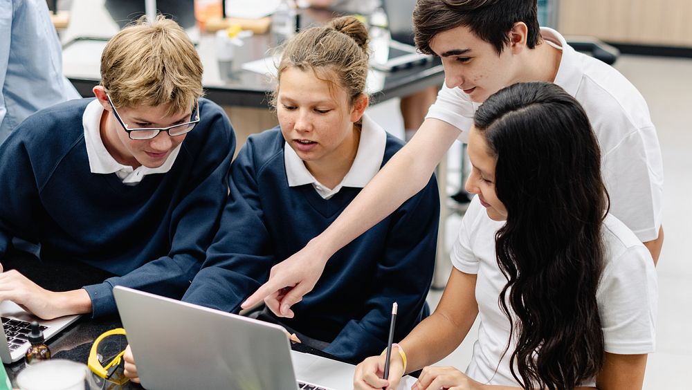 Diverse group of students collaborate in science lab. Diverse students, teamwork, and learning in school classroom. Diverse…