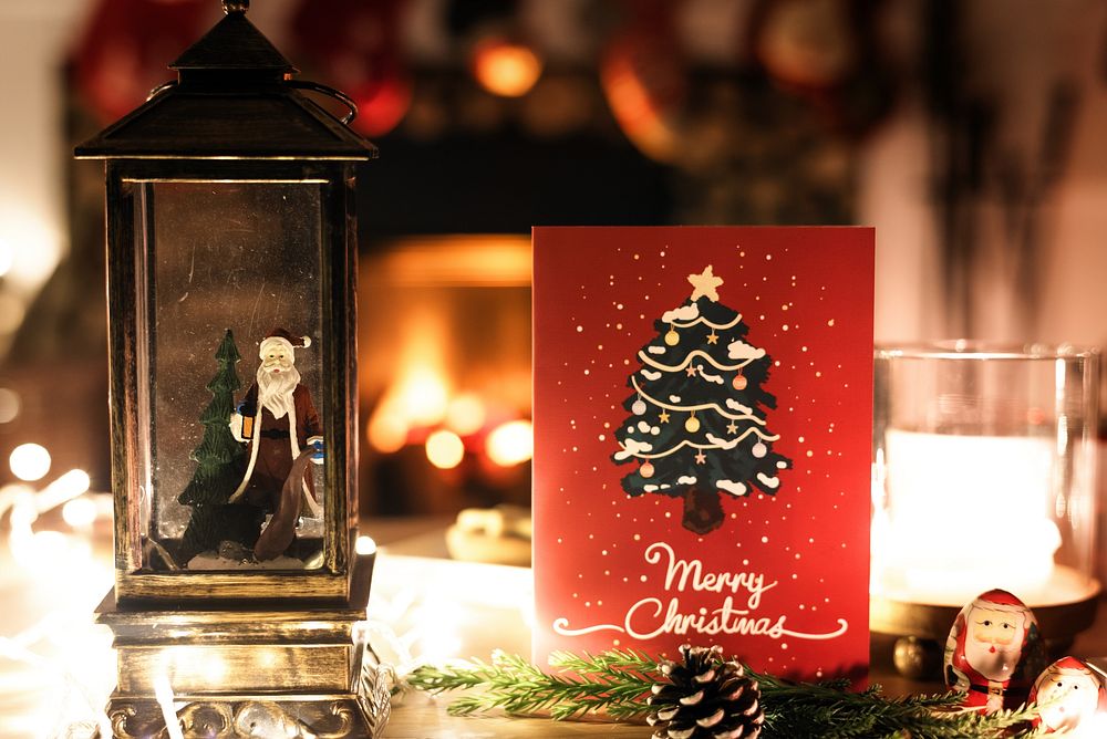 Cozy Christmas scene with a Christmas card, Christmas tree, and Christmas lights. Festive atmosphere with a Christmas card…