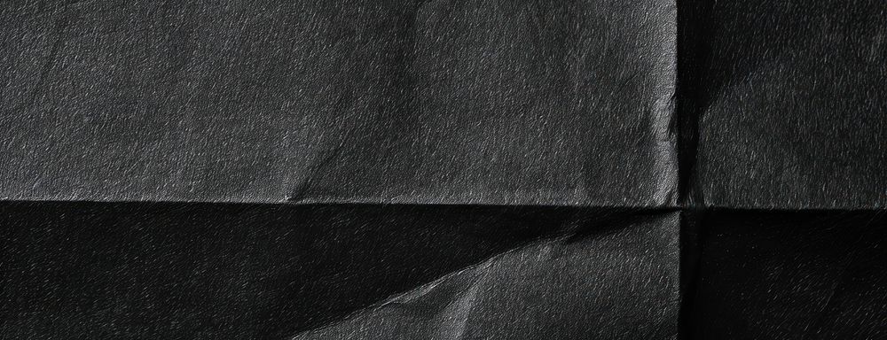 Black folded paper texture background clothing apparel.