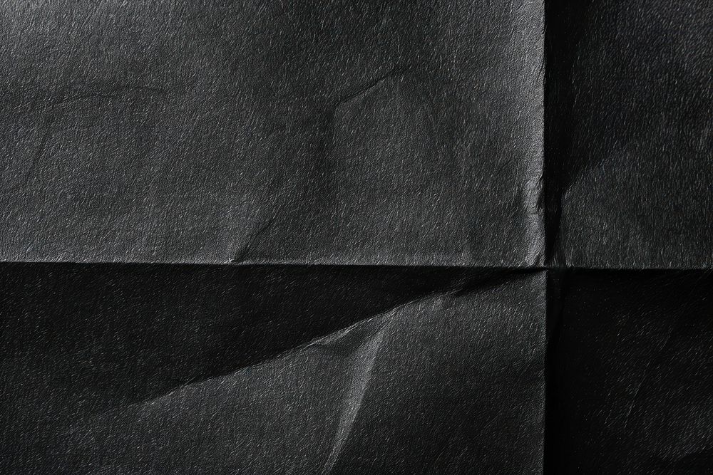 Black folded paper texture background clothing wrinkled.