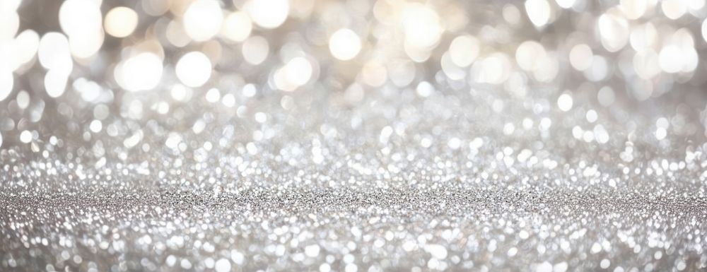 Shimmering bokeh background sparkling blurred silver.