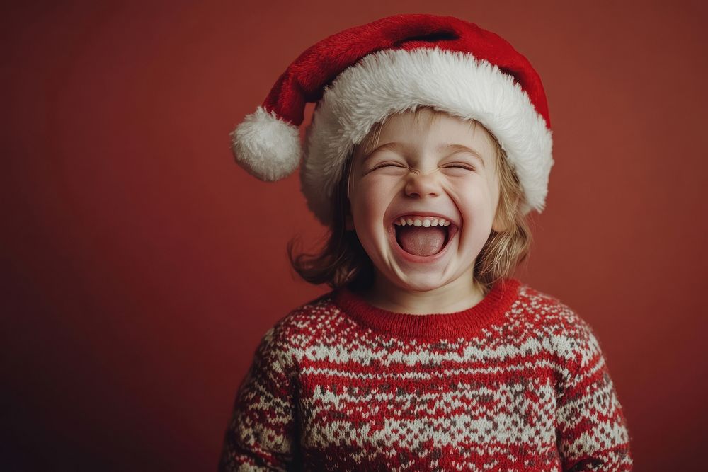 Kid in a sweater happy laughing santa.