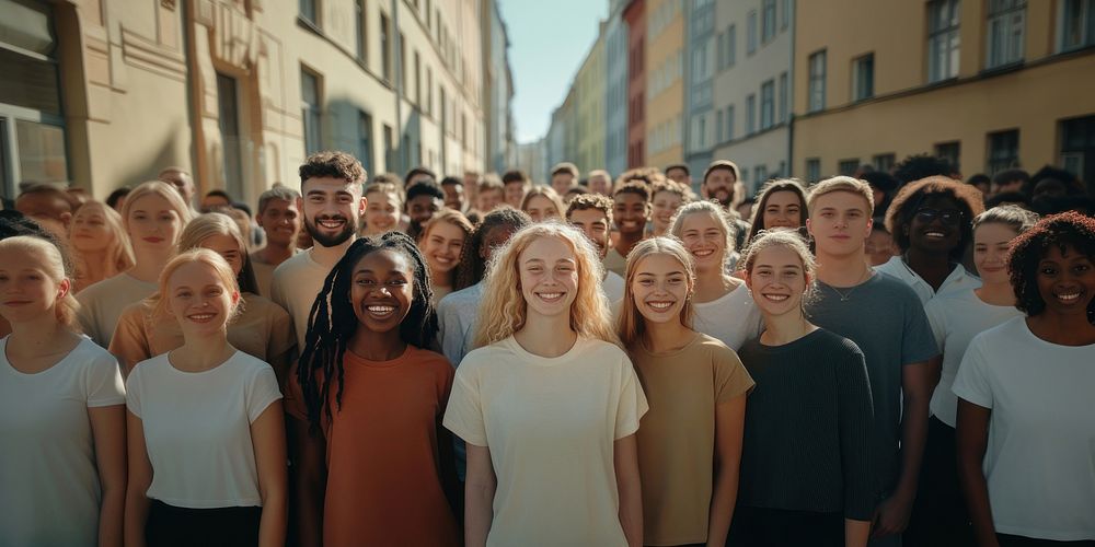 Diverse crowd smiling outdoors.