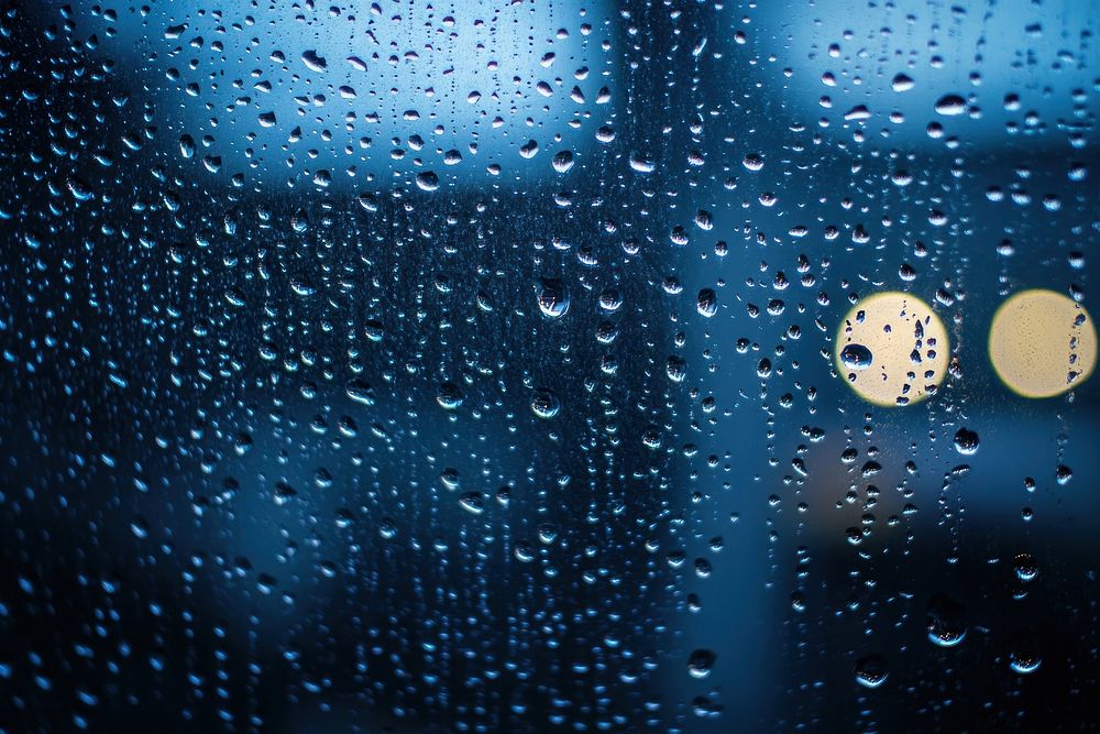 Rainy window with raindrops droplets atmosphere glass.