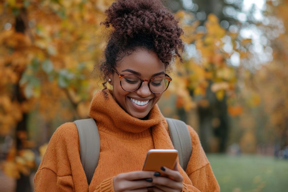 Woman looking at the phone background person autumn.