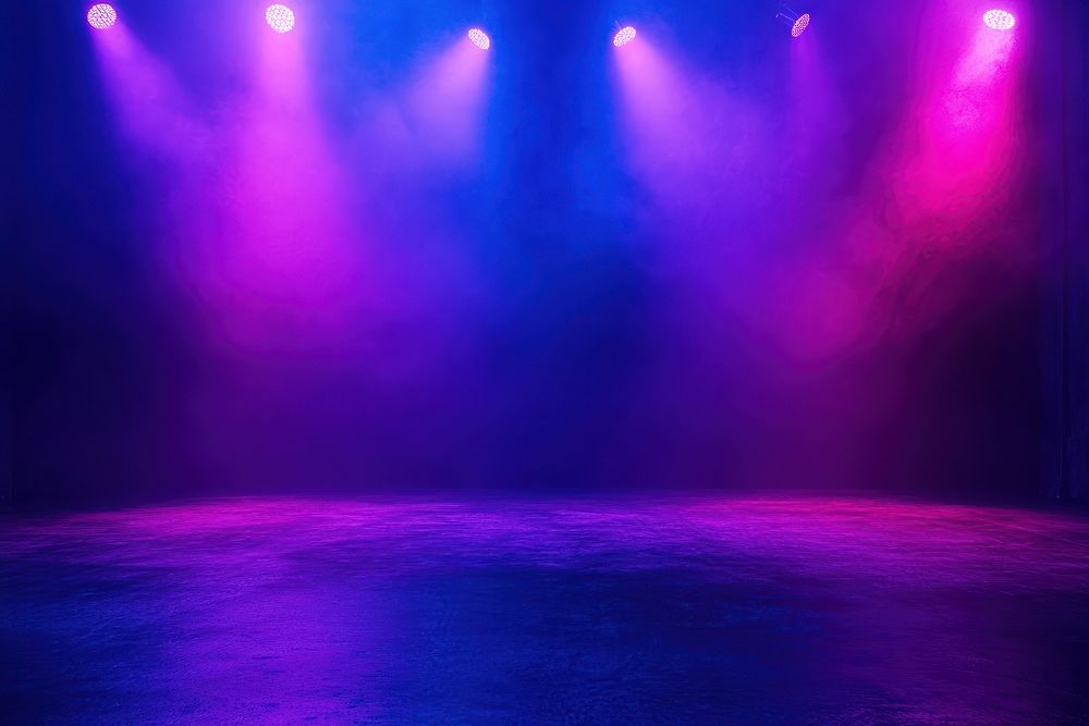 Dark stage shows spotlights purple lighting.