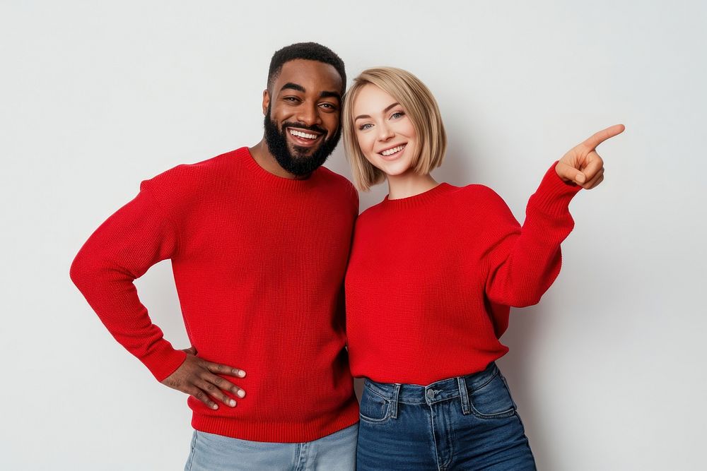 A couple with different races in red crew-neck sweaters and jeans happy smiling person.