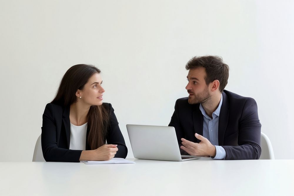 Businesswoman in her 20s and businessmen in his 40s pleasant working with laptop on the table conversation collaboration…