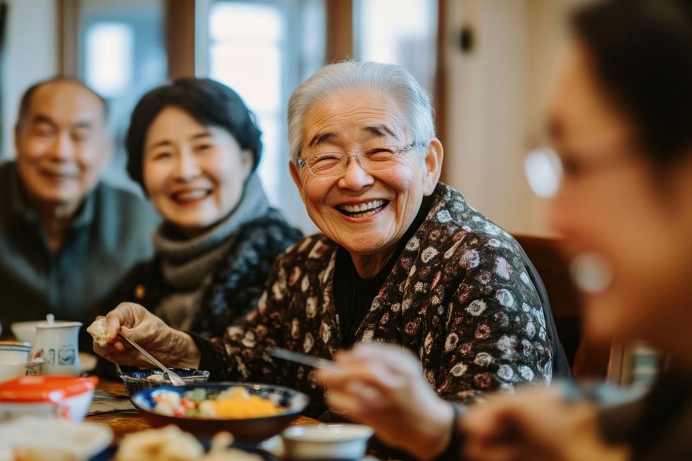 Happy Chinese family and friends having a reunion dinner together at home happy laughing person.