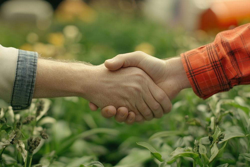 Two farmers shake hands green collaboration partnership.