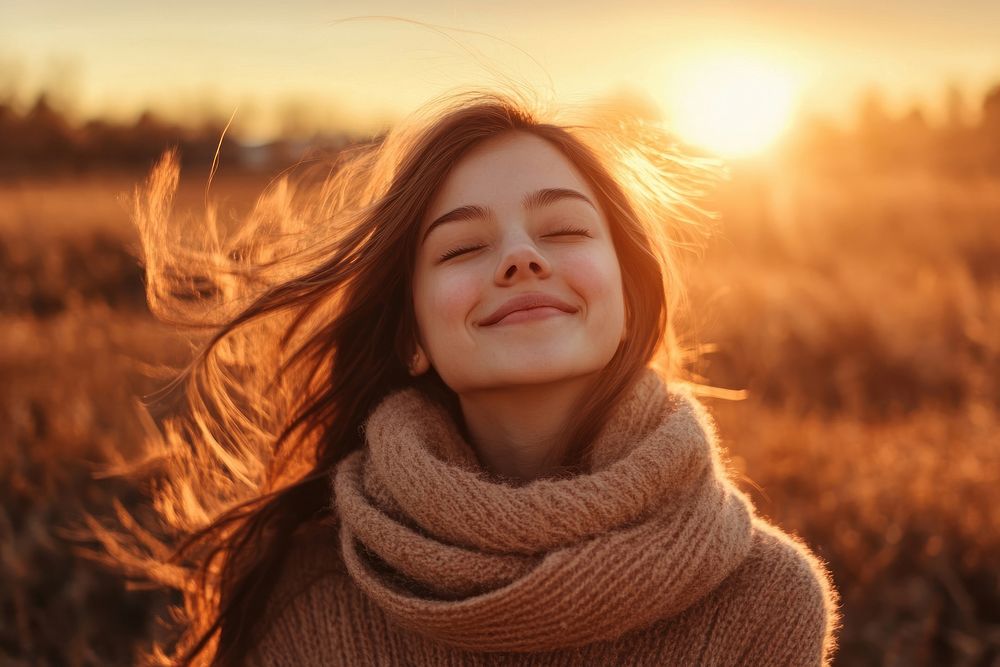 Happy woman outdoors sweater smiling.