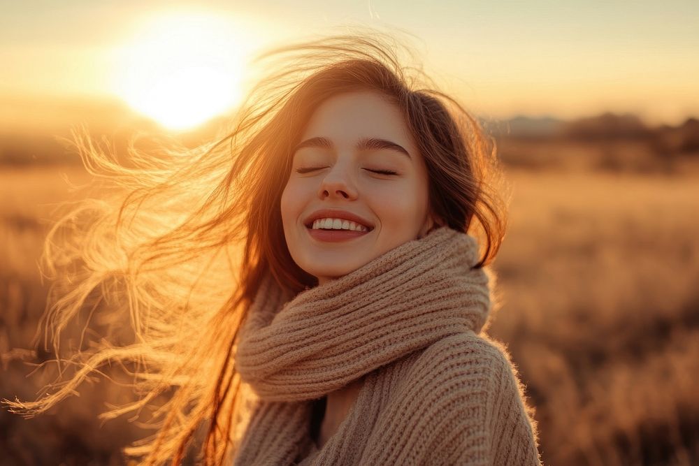 Happy woman smiling sweater sunset.