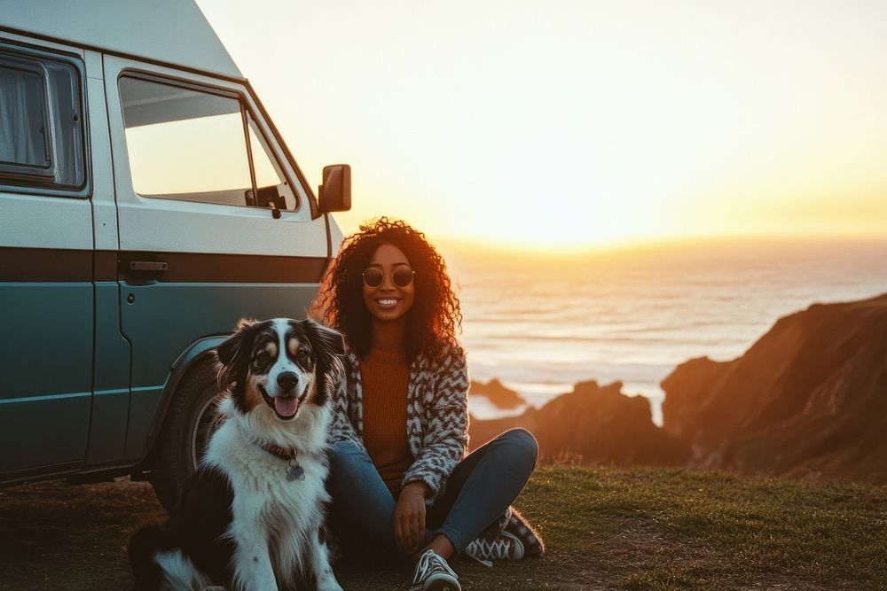 Black woman travel with a dog van photography sitting.