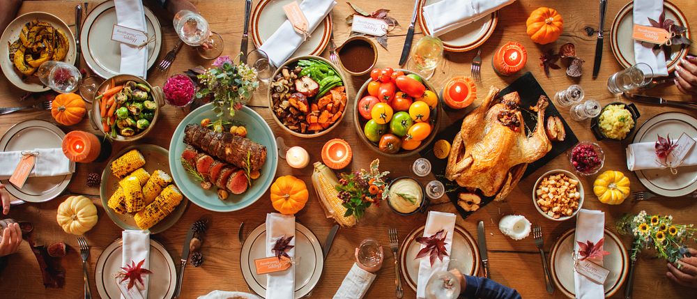 Festive Thanksgiving table with roasted turkey, vegetables, and fruits. Thanksgiving feast with turkey, vibrant vegetables…