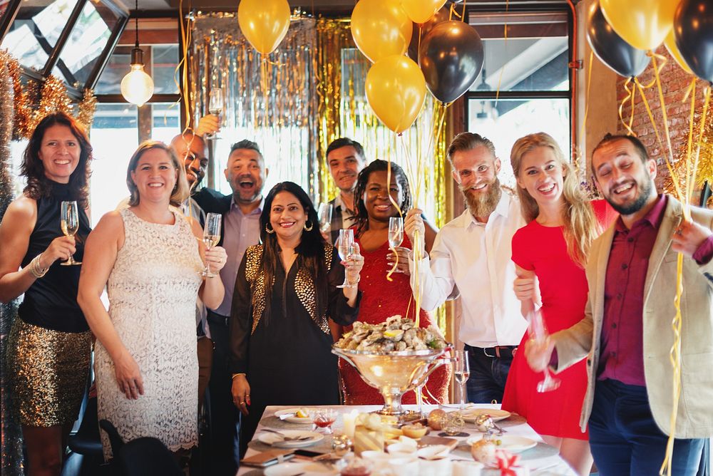 Group of diverse men and women celebrating with champagne. New year party with diverse friends, laughter, and joy. Elegant…