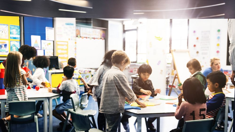 Children in a classroom, diverse group, engaged in activities. Classroom setting with diverse children learning and…