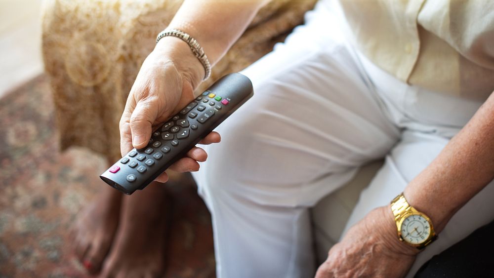 Elderly person holding remote control | Free Photo - rawpixel