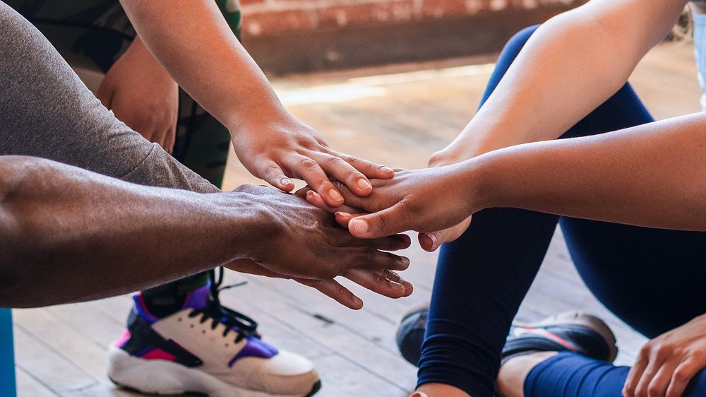 Diverse group of hands stacked in unity. Teamwork and collaboration. Close-up of hands showing support and cooperation.…