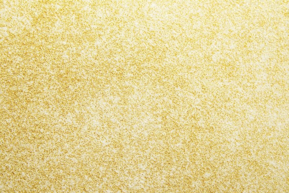 Gold sandpaper-textured background surface golden grainy.