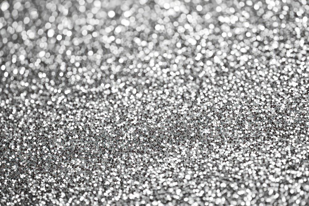 A shimmering light gray glitter texture background sparkling metallic.