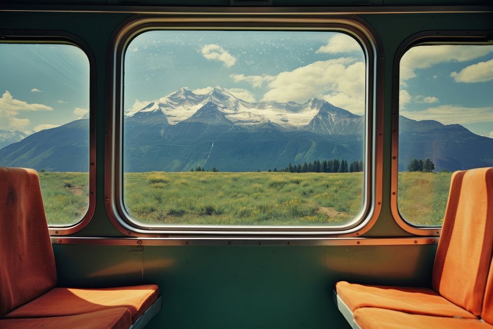 Train interior window mountains scenery nature.