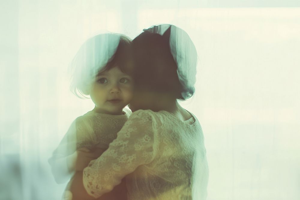 Mother hugging kid photo photography reflection.