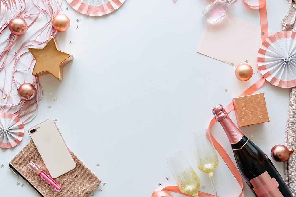 Festive flat lay with champagne, pink decorations, and gift boxes background. Celebration theme with champagne, pink…