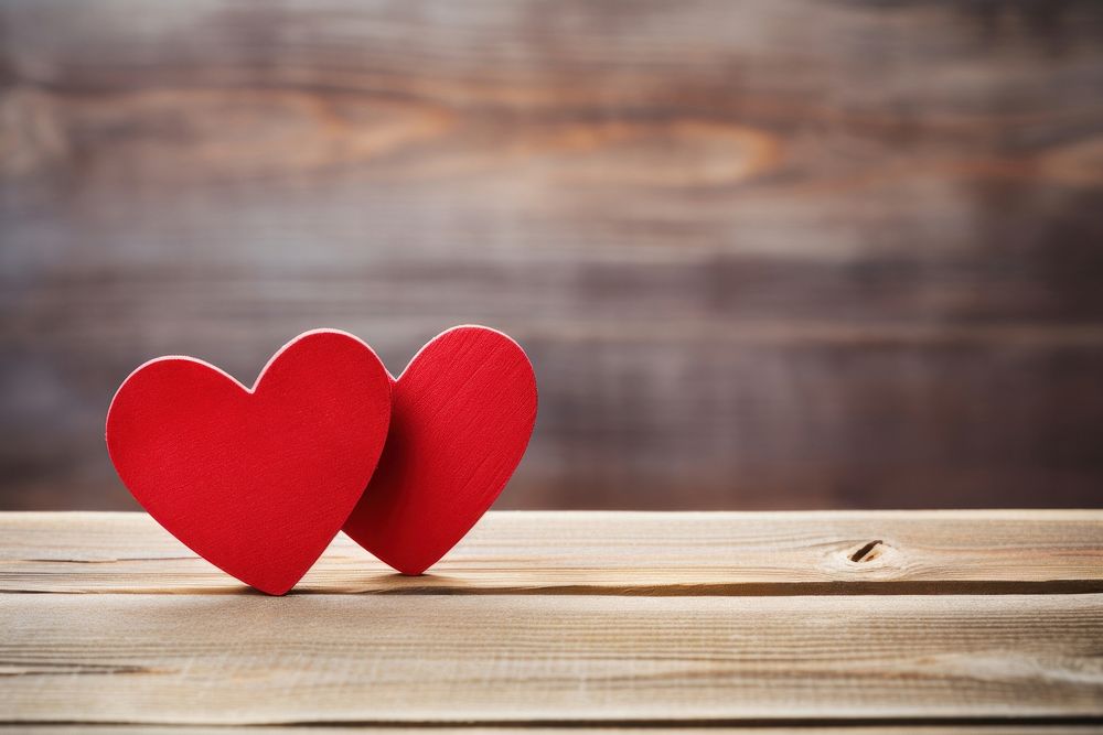 Two red wooden hearts valentine's symbol table.