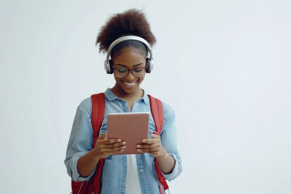 A young Black woman wearing glasses and headphones backpack student smiling.