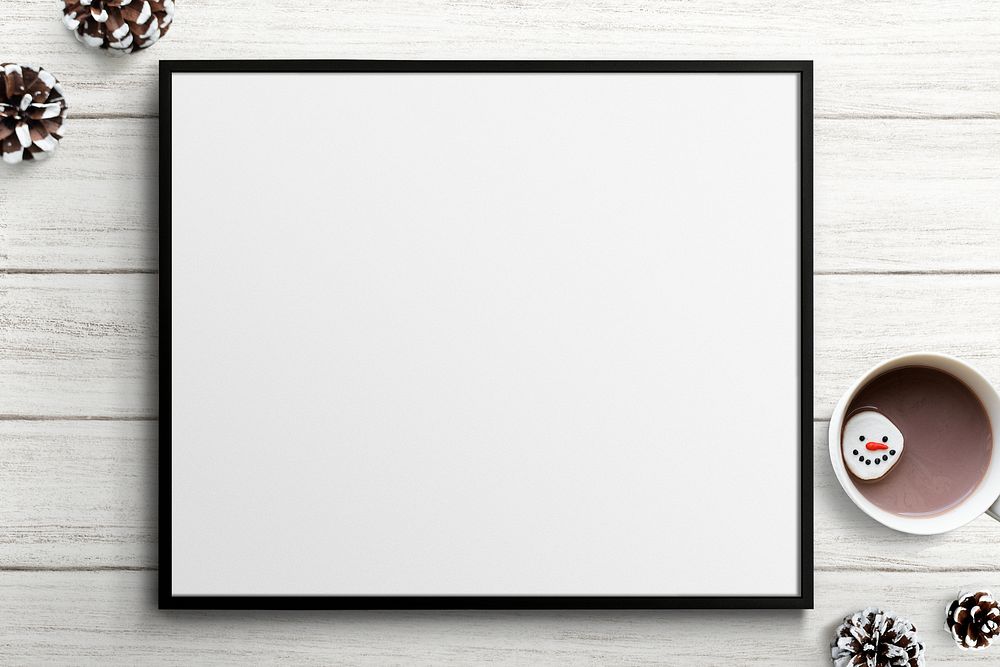 Frame mockup with Christmas decorations on white wooden background