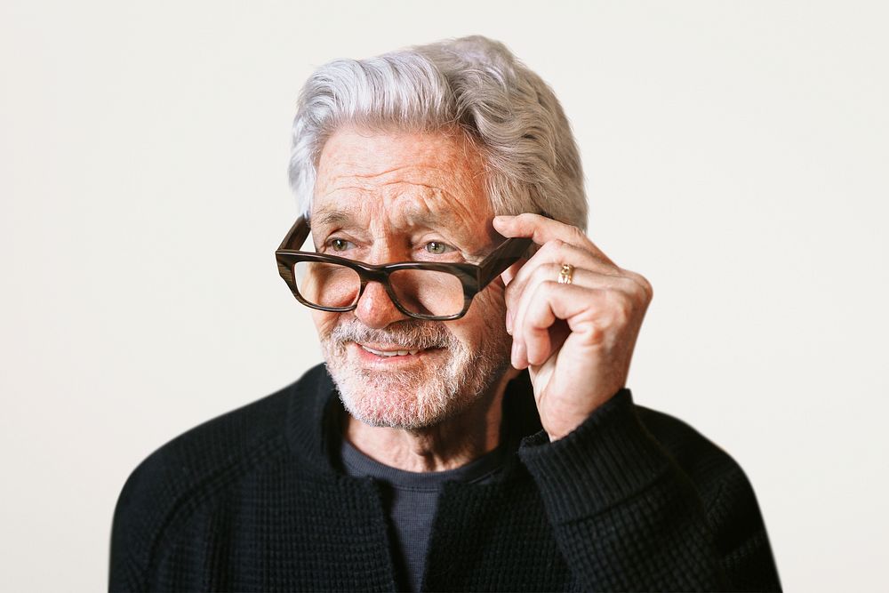 Happy grandfather wearing glasses, isolated on beige