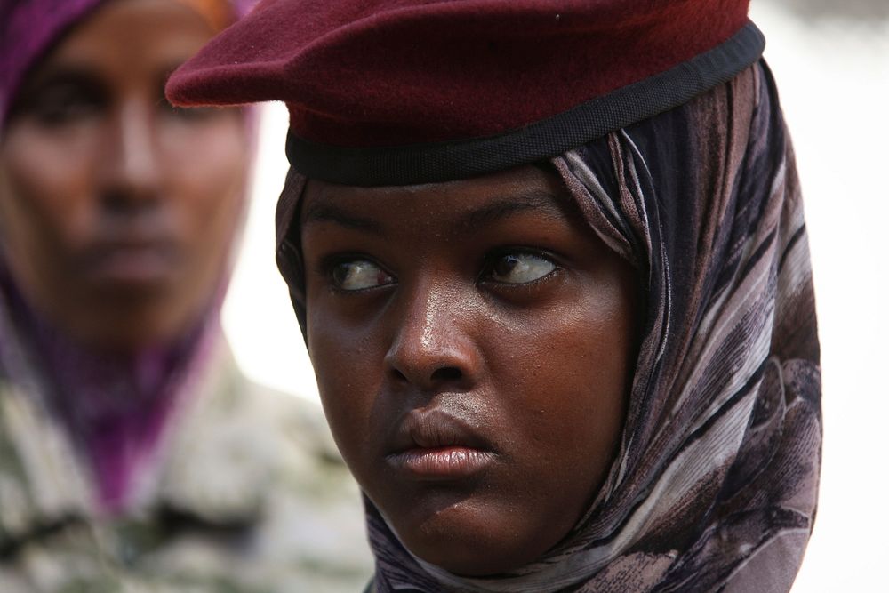 A soldier listens to Djiboutian Contingent Commander Osman Doubad speaking to members of the Somali National Army at Lama…