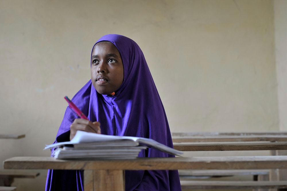 A Somali girl writes in her excercise book during class at as school run by the Abdi Hawa Center in the Afgoye corridor on…