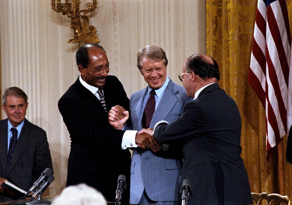 Triple handshake with Carter, Sadat, and Begin in the East Room, September 17, 1978Photo courtesy of Jimmy Carter Library.…