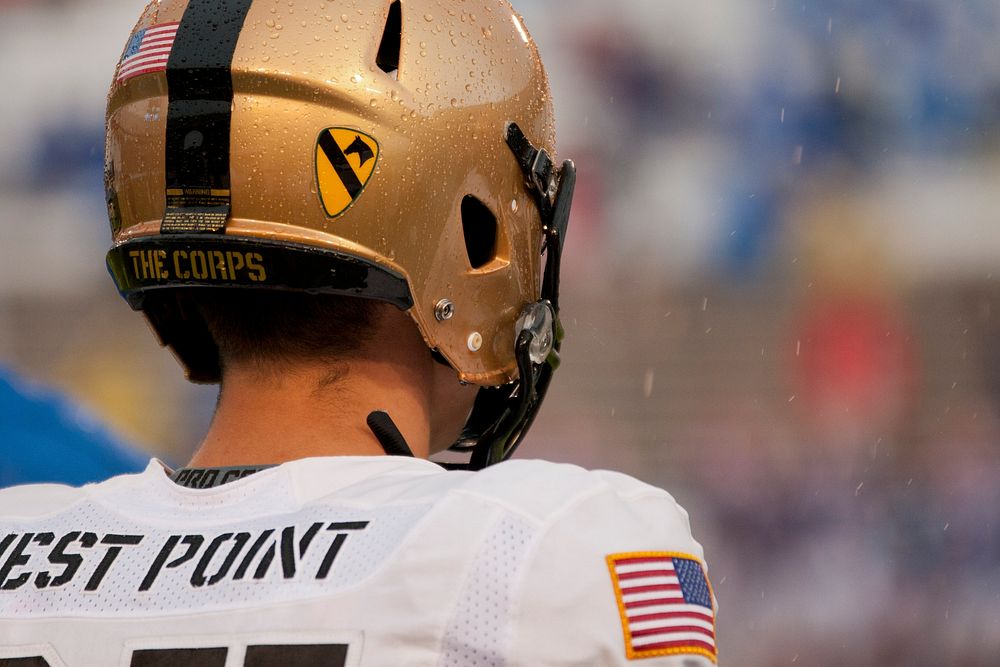 The insignia of the U.S. Army's 1st Cavalry Division is displayed on the helmet of an Army Black Knights football player…