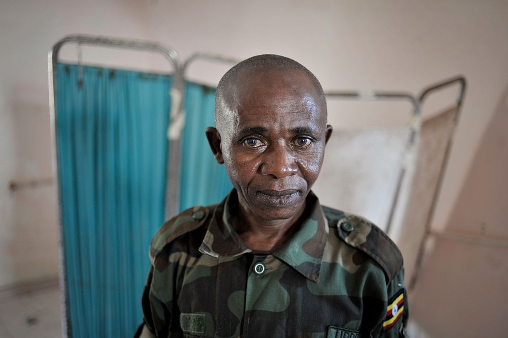 A Ugandan medic, part of the African Union Mission in Somalia (AMISOM), stands in front of an examining table at a medical…