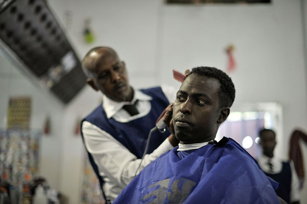 A hairdresser gives a haircut at Abdulqadir Abdul's newly opened barber shop in Mogadishu, Somalia, on January 20. AU UN IST…