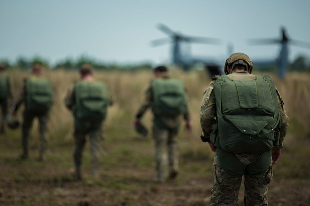 U.S. Army special operations forces walk to a Marine Corps MV-22 Osprey tiltrotor aircraft to conduct a high-altitude, low…