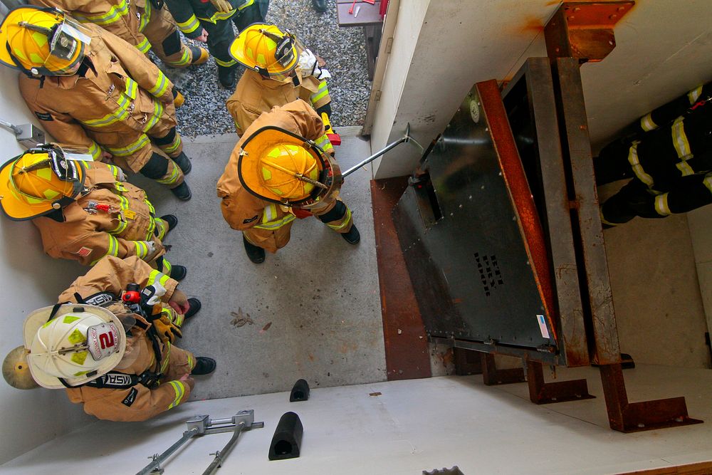 A U.S. Air Force fire protection specialist from the New Jersey Air National Guard's 177th Fighter Wing uses a Halligan bar…