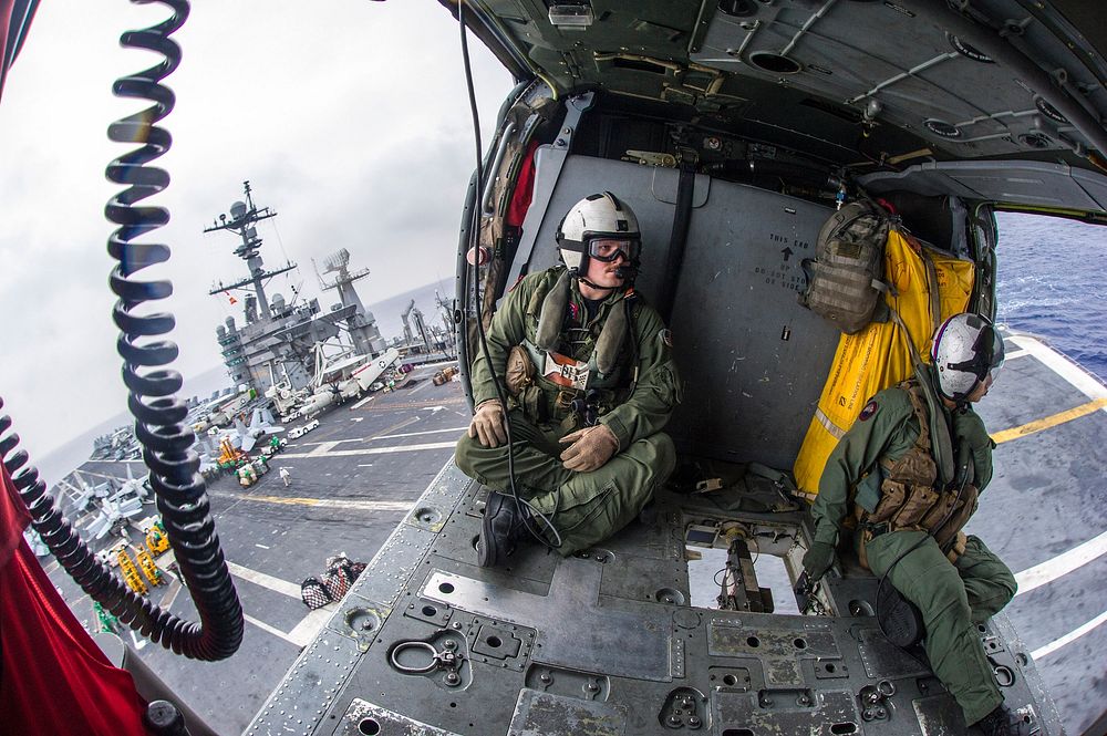 U.S. Naval Aircrewmen (Helicopter) 2nd Class Wesley Adams, left, and Brad Popoff, both assigned to Helicopter Sea Combat…