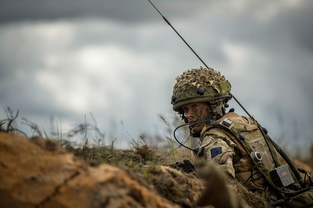 A British soldier surveys the battlefield from a defensive position during a training lane as part of Saber Strike 2014 in…
